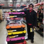 Safeload employee delivering hard plastic toolboxes to a store